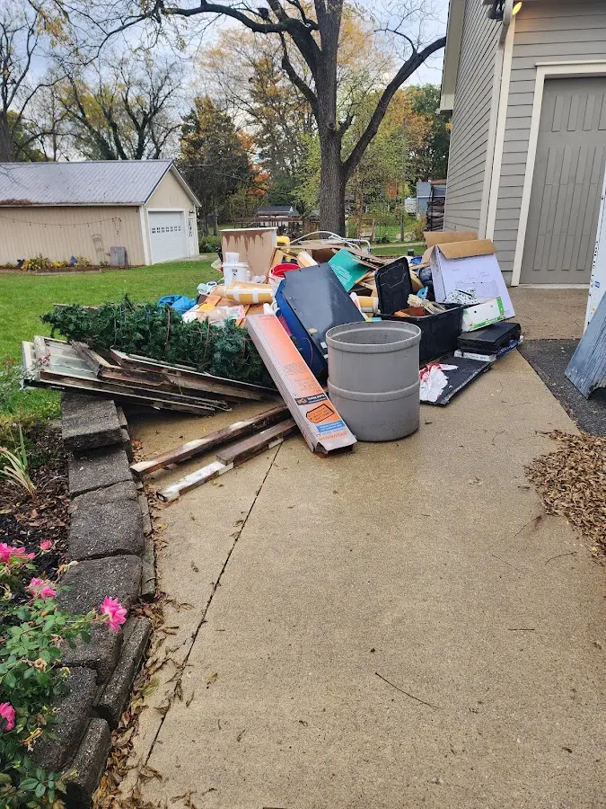 Dumpster being loaded with debris for Demolition Dumpster Rental in Red Bud